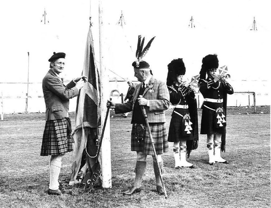 Opening ceremony. The Earl of Aboyne raises the flag to open the Highland Games at Aboyne this morning. Looking on is his father, the Marquess of Huntly. August 1979
