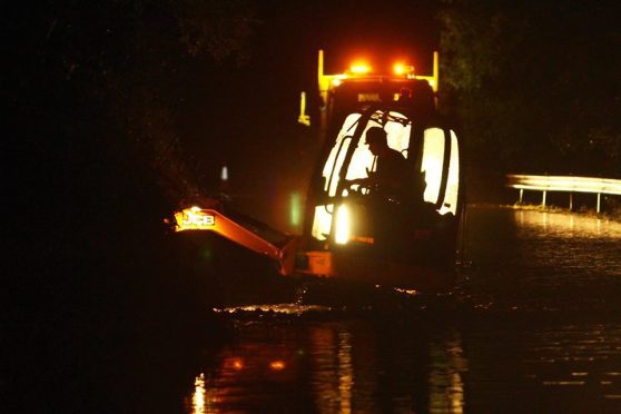 Workers are on through the night trying to clear A85 flooding
