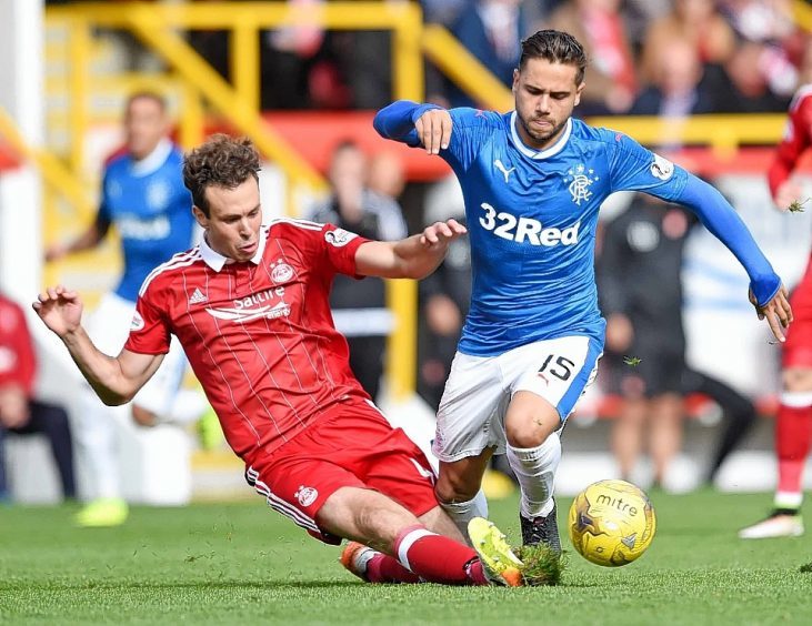 Aberdeen's Andrew Considine tackles Rangers' Harry Forrester
