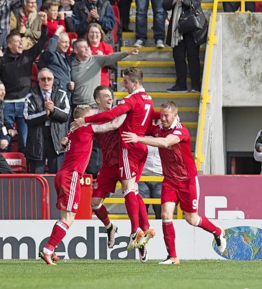 Jonny Hayes is mobbed by team-mates after putting Aberdeen ahead