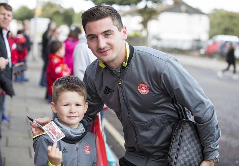 Aberdeen's Kenny Mclean with a fan  during the Ladbrokes Scottish Premiership match at the Pittodrie Stadium, Aberdeen.