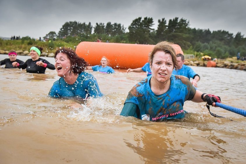 People enjoying Knockburn Loch obstacle course