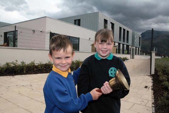 Coby Fyfe (left) of Caol Primary School and Emma McPhail of Lochyside Primary School ring the changes as both their schools close ready for the move into the new school behind them