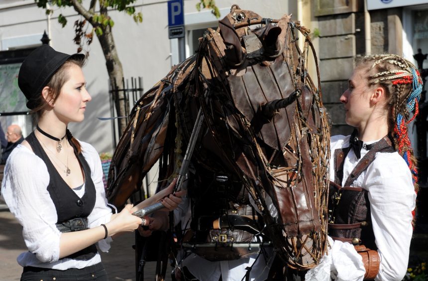 Ciara Turnbull, left, and Hannah Myers, right, with mechanical horse from Arts In Motion.