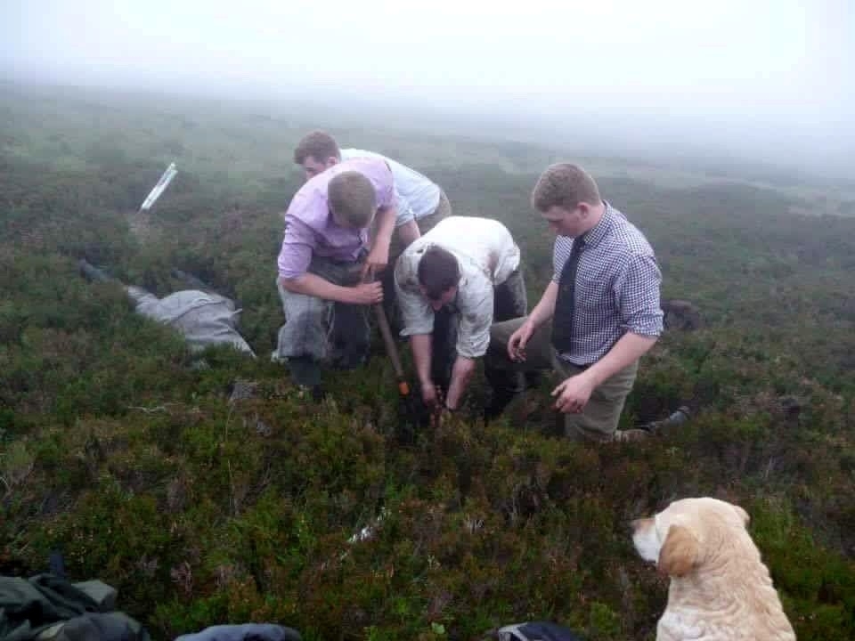 Team Invermark digging out Jazz. See Centre Press story CPHOLE; These dramatic pictures show a brave gamekeeper climbing head first into an underground pipe to rescue a dog who went missing on an Angus moor. Cocker spaniel Jazz disappeared while picking up game during a grouse shoot at the Invermark Estate on Tuesday. She was eventually found down a muddy open pipe on the moor. Gamekeepers dug through 6ft of wet peat to retrieve her Jonny Stevenson pushed himself down the pipe to check on the spaniel's condition.