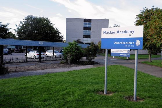 Mackie Academy. Social distancing guidance meant pupils were forced to stand outside in a storm on Tuesday.