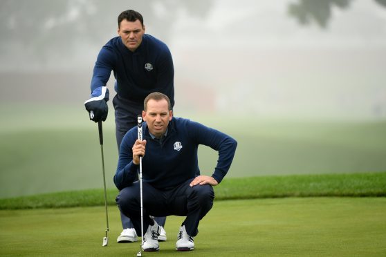 Martin Kaymer and Sergio Garcia of Europe line up a putt