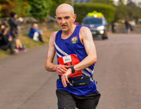 Connell Drummond crosses the finish line after completing the unintended 30-mile marathon.