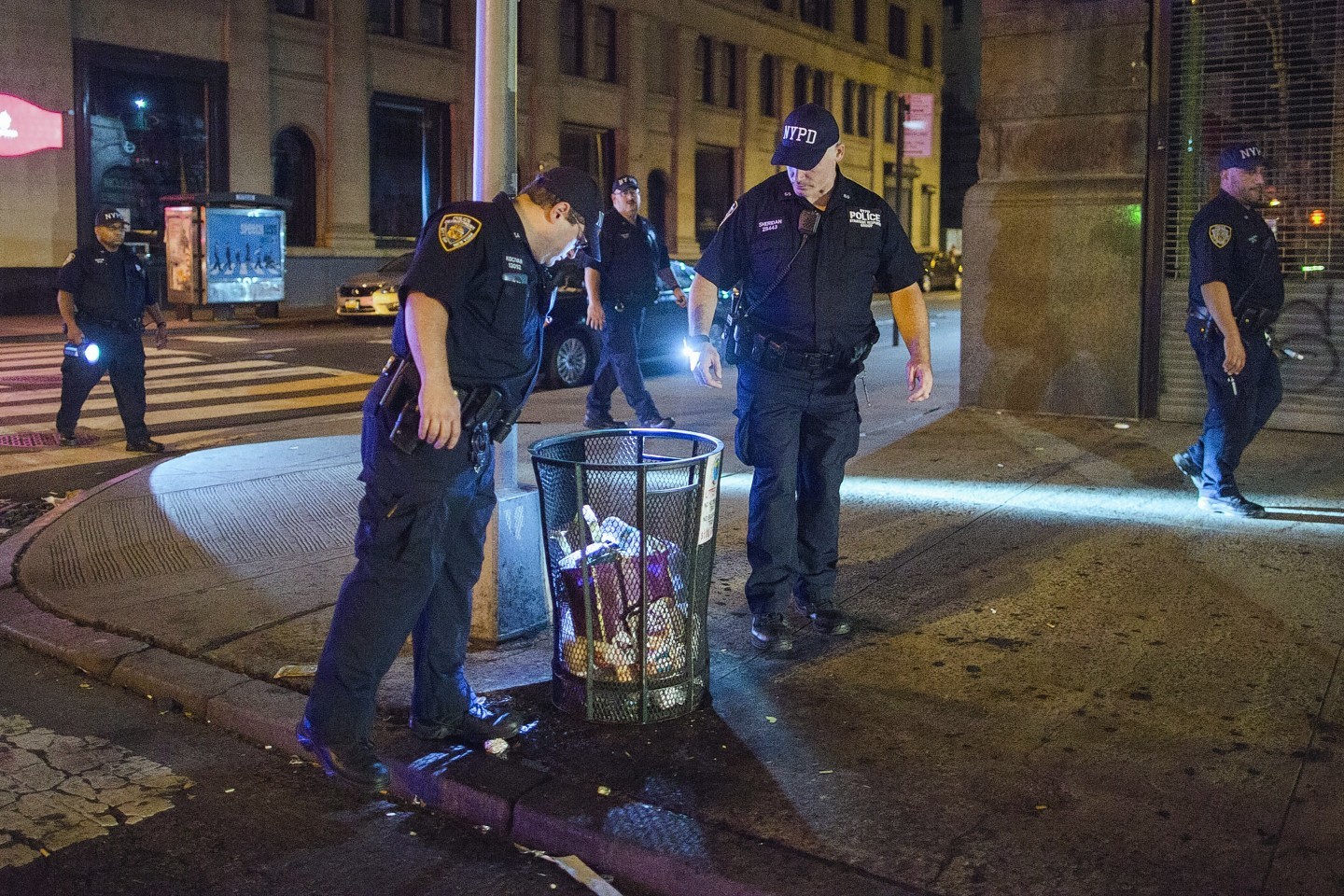 Police officers look for suspicious packages along Fifth Avenue