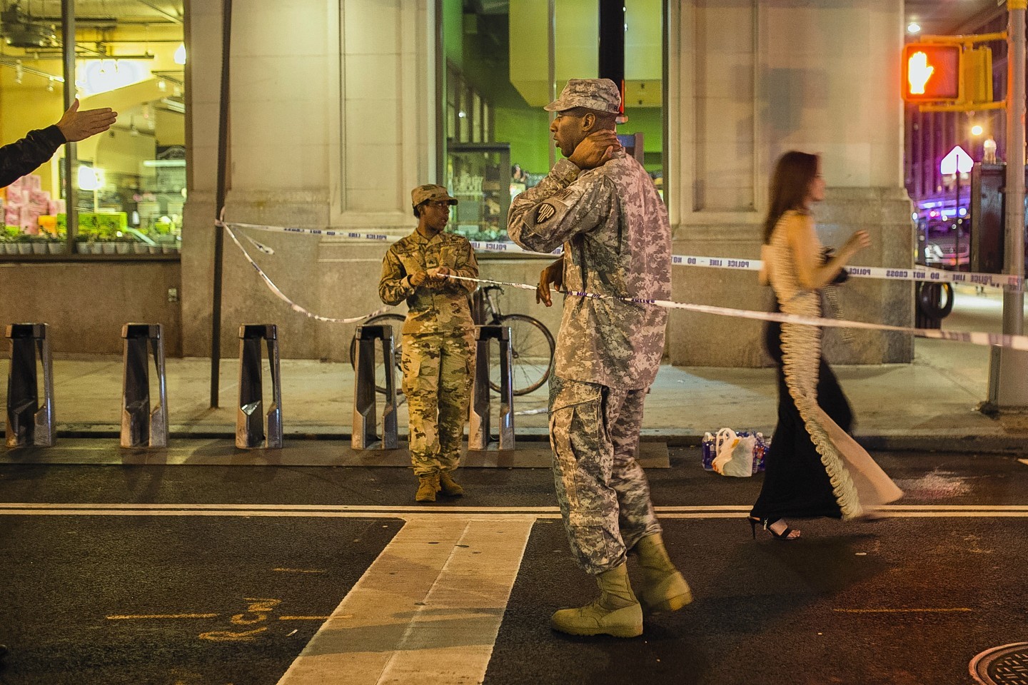 People try to access the area near the scene of an explosion on West 23rd Street and 6th Avenue