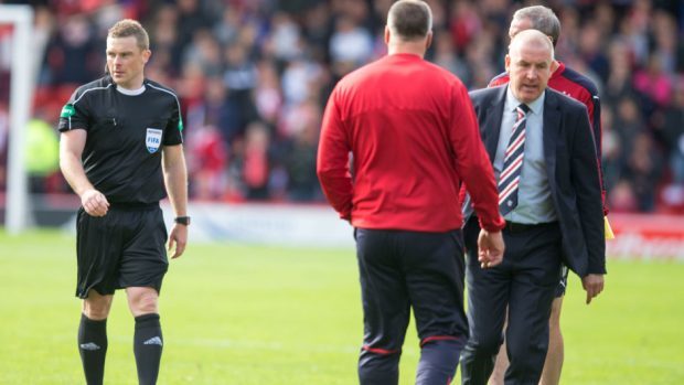 Mark Warburton, right, could not hide his frustration at match referee John Beaton, left.