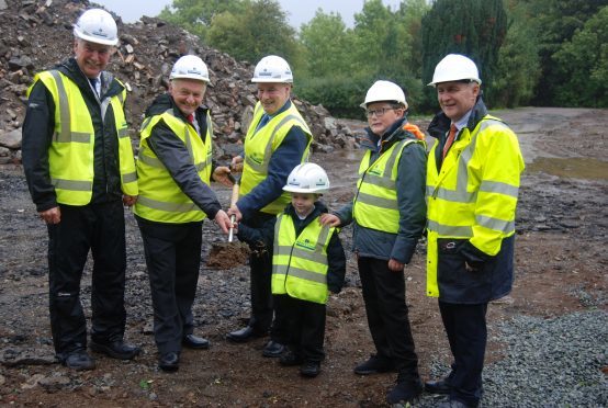 Portree Primary School pupils Jaiden Jones and Steven Colven help Councillors Drew Millar and Hamish Fraser cut the first turf for their new Gaelic school