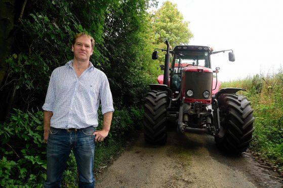 Farmer William Lyness demonstrates how narrow the road is.