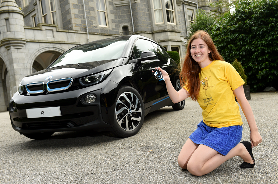 ARCHIE fundraising manager Emma Slesser outside Mercure Aberdeen Ardoe House Hotel with the all-electric BMW i3.