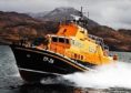 The Mallaig Severn Class Life boat in orange and navy colours out at sea.