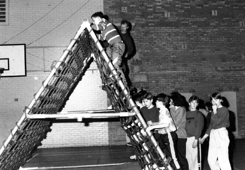 Pupils get to grips wit army mobile assault course. February 1992