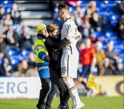 Struan Balfour celebrates with pal Miles Storey before being arrested for pitch invasion.