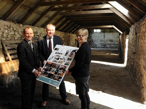 Grant Gordon, chairman of the Cabrach Trust, left, and Sue Savege, executive director of the Cabrach Trust, right, show details of the interior to Richard Lochhead, MSP, centre.