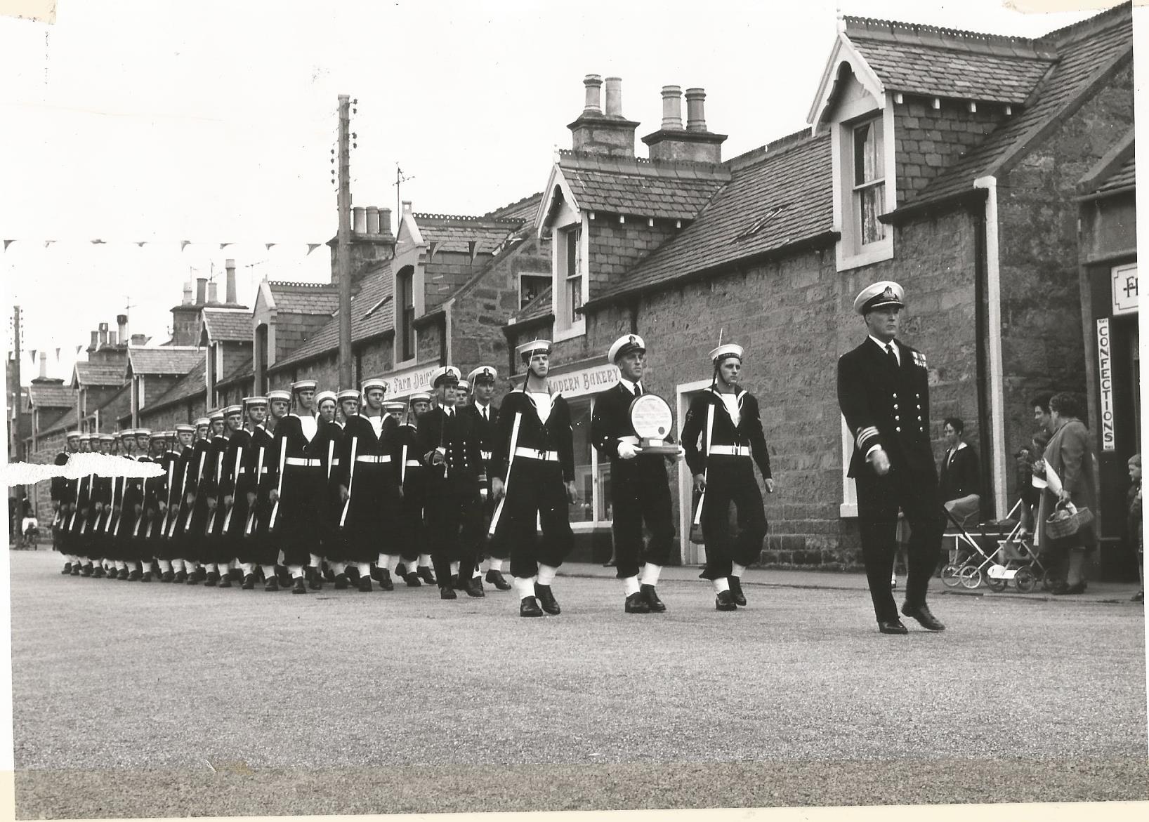 HMS Fulmar personnel parade along Lossiemouth's Queen Street in 1967