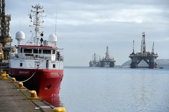 Invergordon port with ship and oil rigs in background