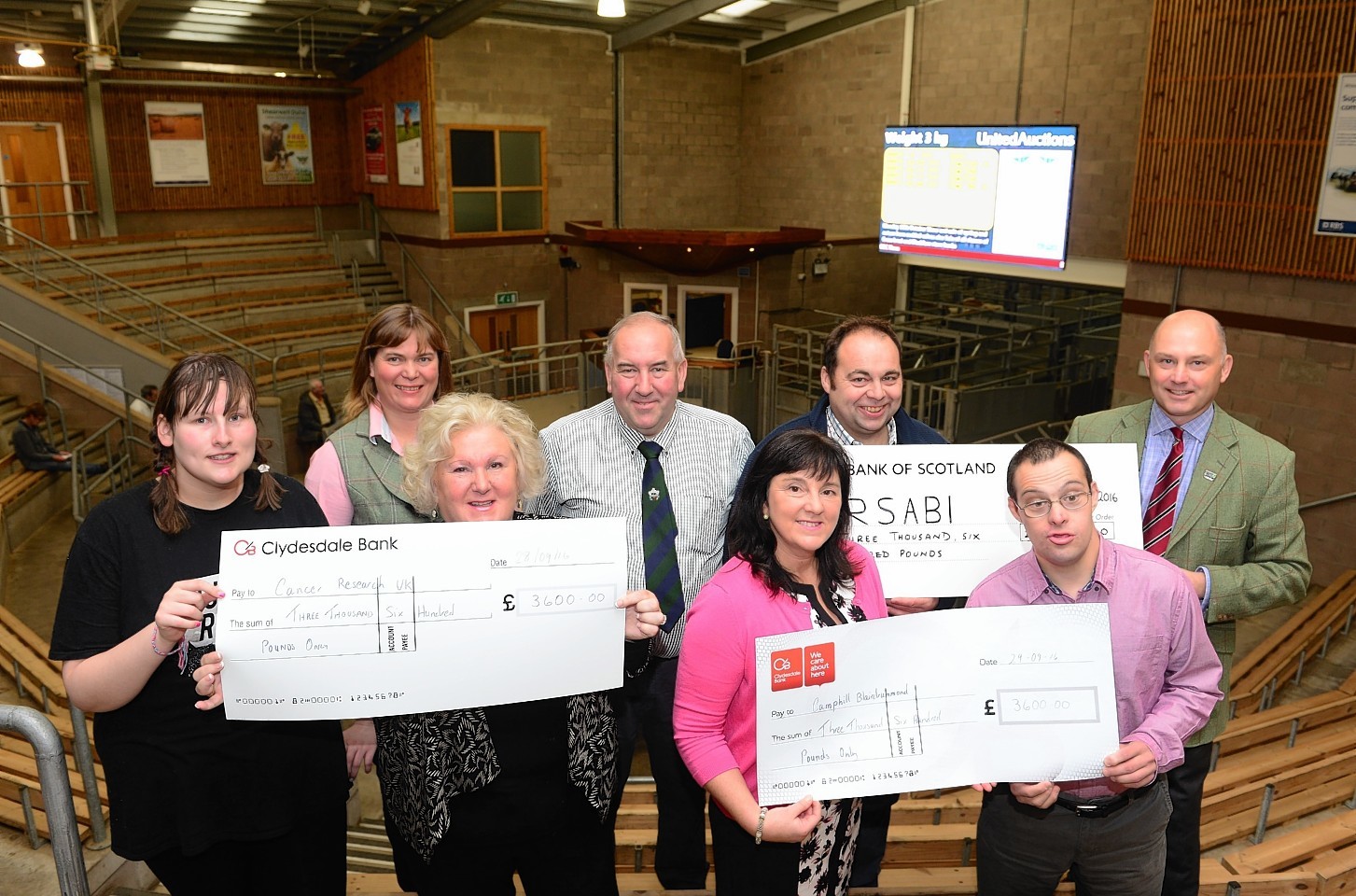 Gavin Ross, back row third left, and Lindsey Ross, back row left, with the recipients of the donations.