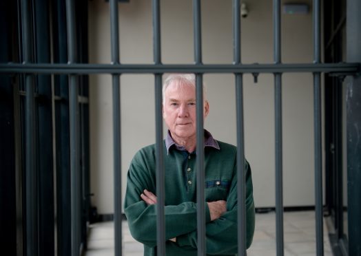 Caol Regeneration Company chairman Donnie Corbett behind the bars around the library at the new school campus
