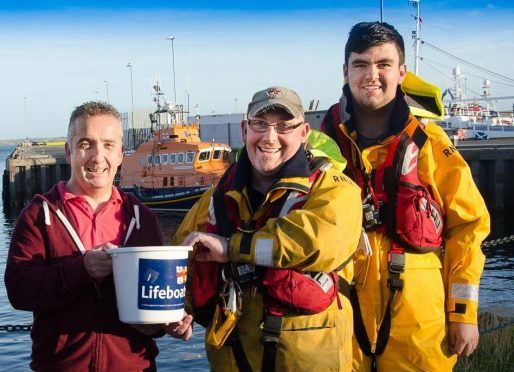 Graham Duthie hands his donation over to Victor Sutherland of Fraserburgh lifeboat station.