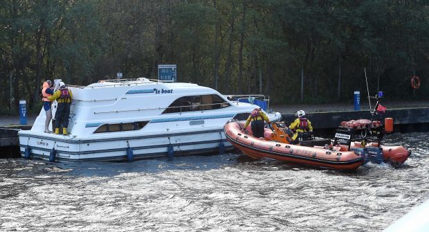 The Loch Ness RNLI Lifeboat crew deal with the cabin cruiser which went aground in Urquhart Bay , picture by Sandy McCook