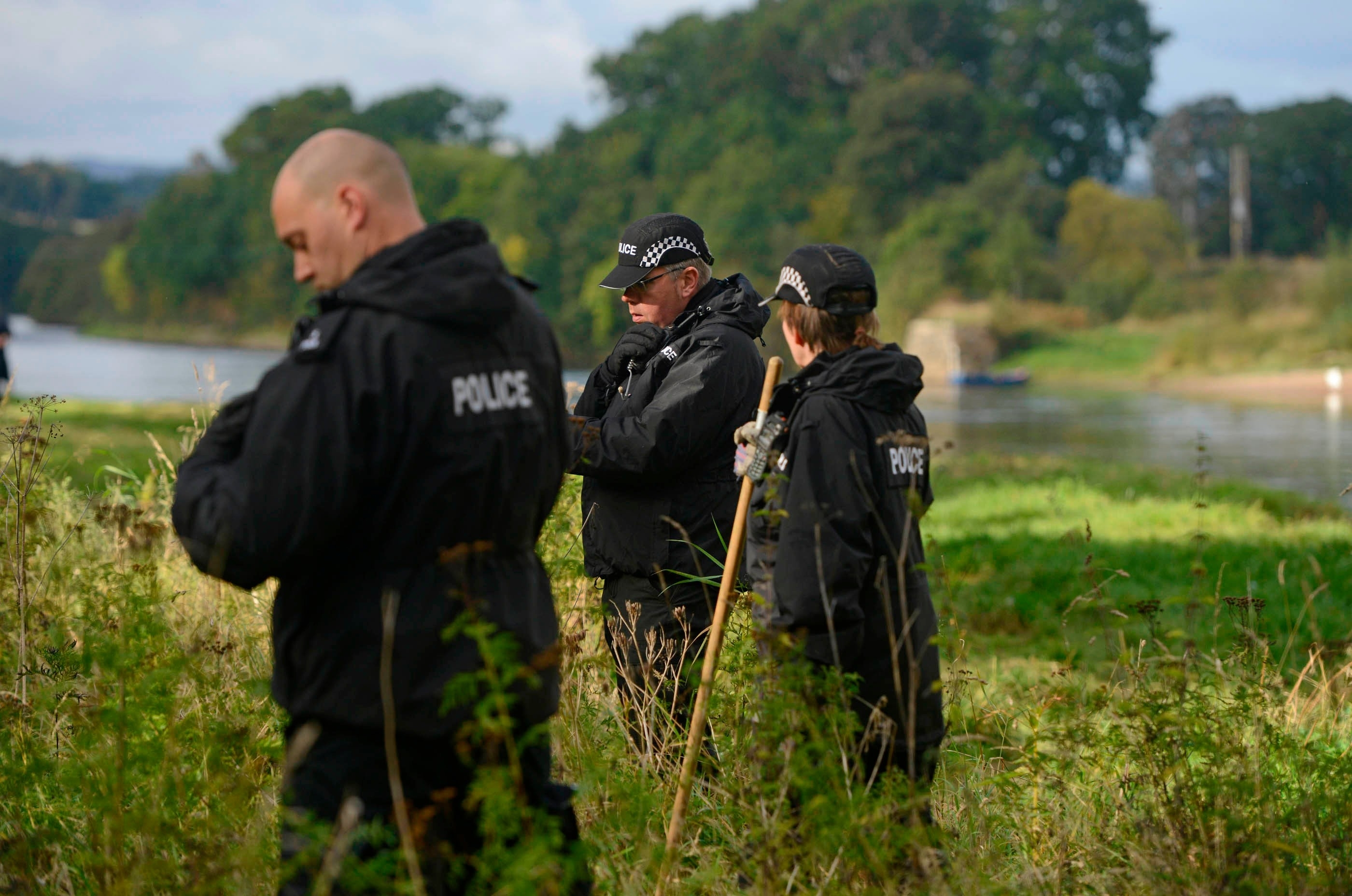 Mountain rescue teams search the banks of the River Tay