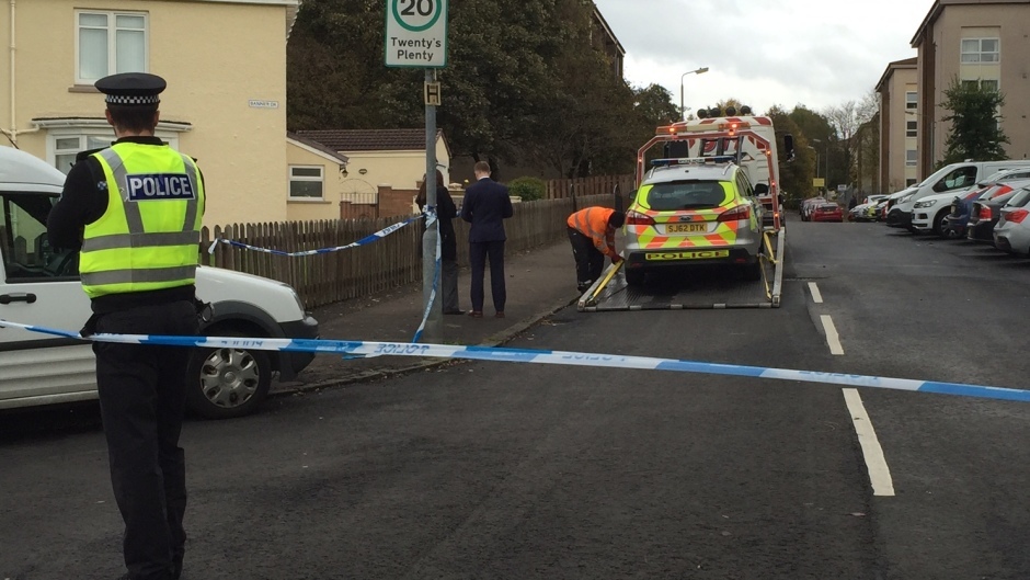A police car is removed from the scene in the Drumchapel area of Glasgow