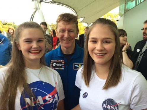 Elgin High School pupils Kirtsen Flett, left, and Ellen O'Hare, right, meet astronaut Tim Peake in Edinburgh.