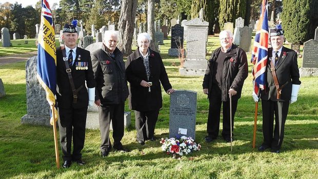 Relatives pay their respects to a WWI hero at a ceremony at Nairn Cemetery.