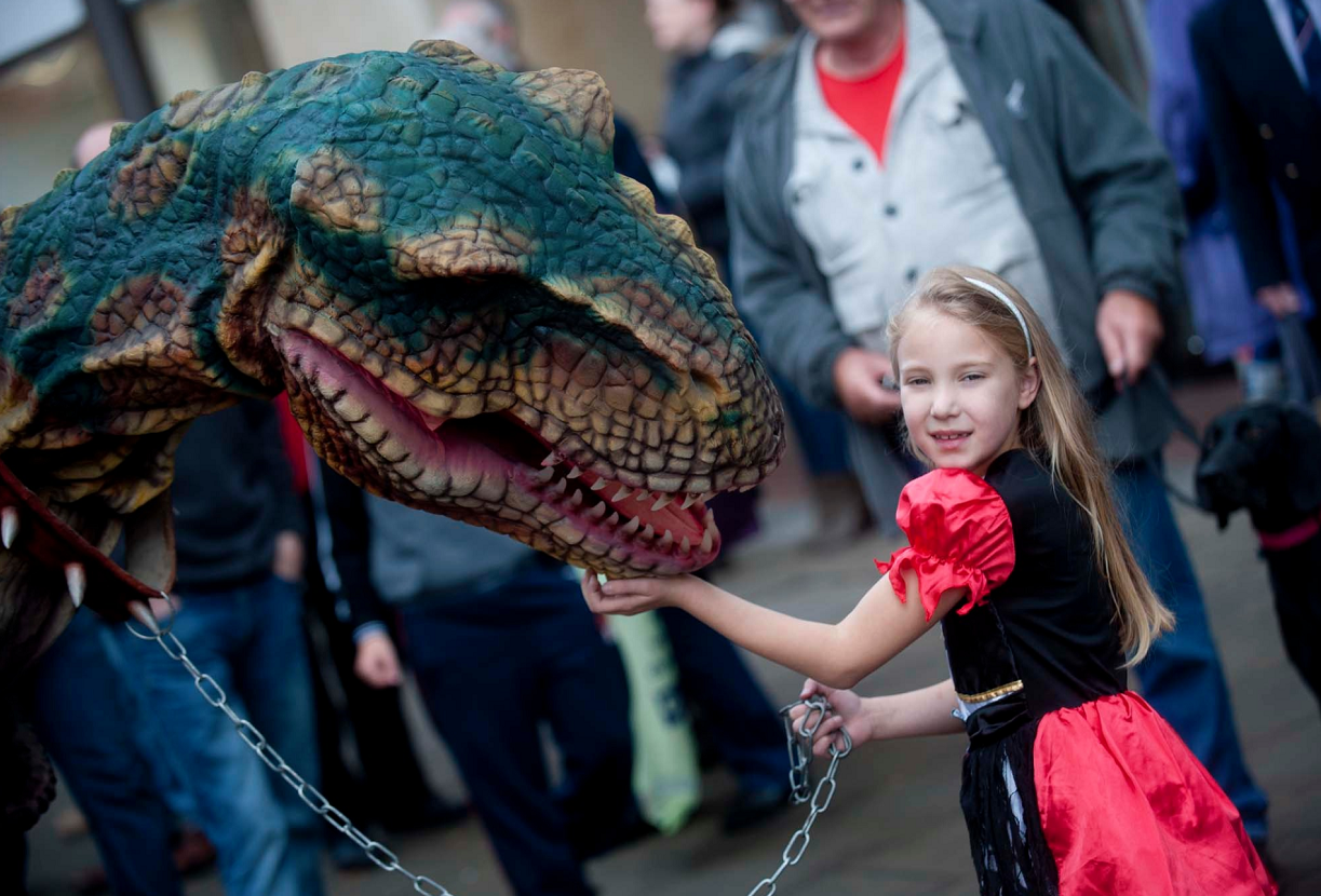 Caydance Krugel, 8, led the dinosaur on a chain through Elgin's town centre.