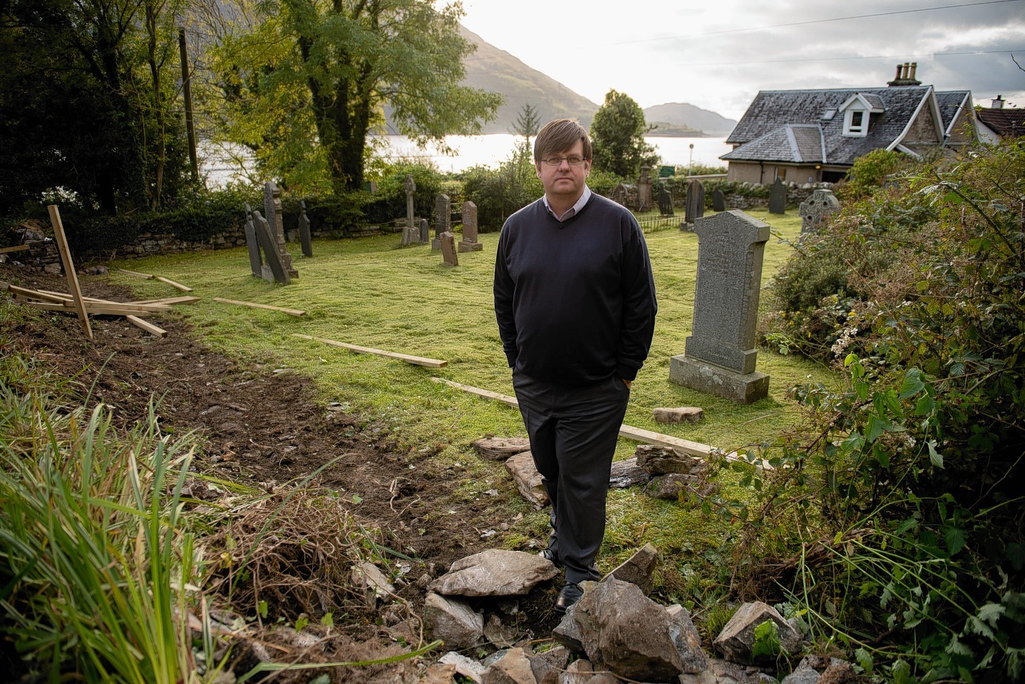 Councillor Andrew Baxter at the cemetery in Onich.