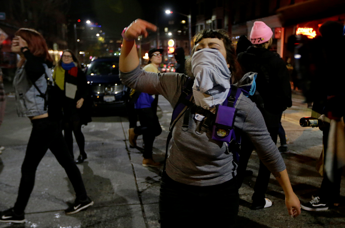A woman yells as she takes part in a protest against President-elect Donald Trump, Wednesday, Nov. 9, 2016, in Seattle's Capitol Hill neighborhood. (AP Photo/Ted S. Warren)