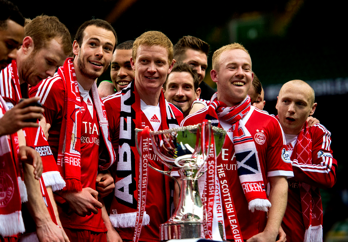 Andrew Considine, left, with the League Cup in 2014.