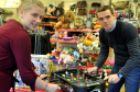 Barnardo's store worker Rachel Bowler, left, and Douglas Ross MSP, right, take time out from a busy day to try out some of the toys donated to the store. Picture by Gordon Lennox.