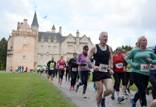 Runners settle into their rhythm after the start at Brodie Castle.