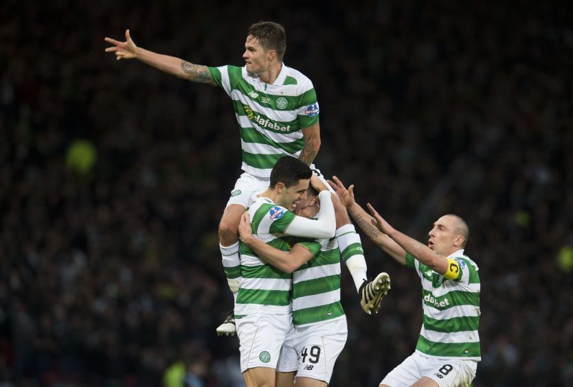 Celtic's Mikael Lustig (top) leads the celebration as James Forrest (49) scores his sides second