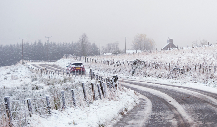 A driver travels through the snow near Ley, Aberdeenshire.