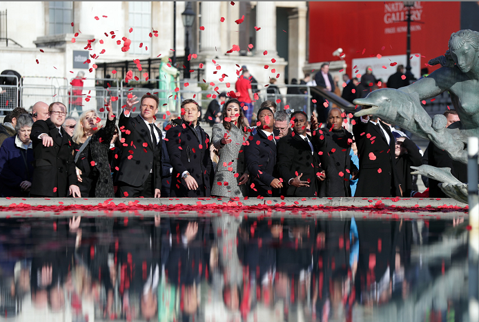 Members of the public throw poppies in the fountain during an event in London's Trafalgar Square (Yui Mok/PA Wire)