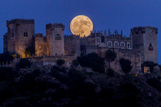 The moon rises behind the castle of Almodovar in Cordoba, southern Spain (AP Photo/Miguel Morenatti)