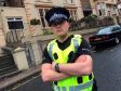 Constable David Dinnen  tackled a man with two meat cleavers outside a school in Glasgow