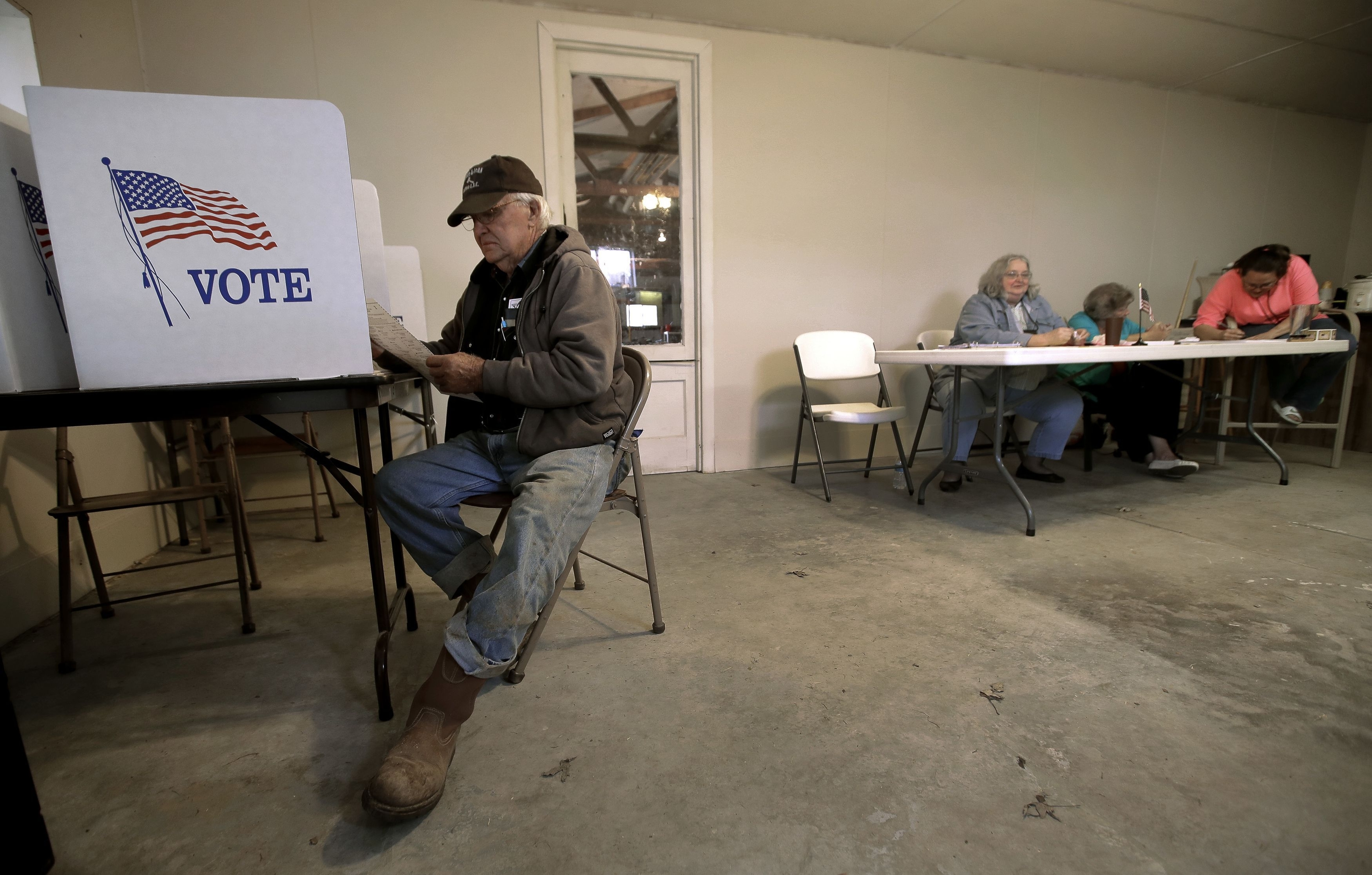 Russell Madison, from Humansville, Mo., votes in a game room on a family farm Tuesday, Nov. 8, 2016 near Humansville, Mo. (AP Photo/Charlie Riedel)