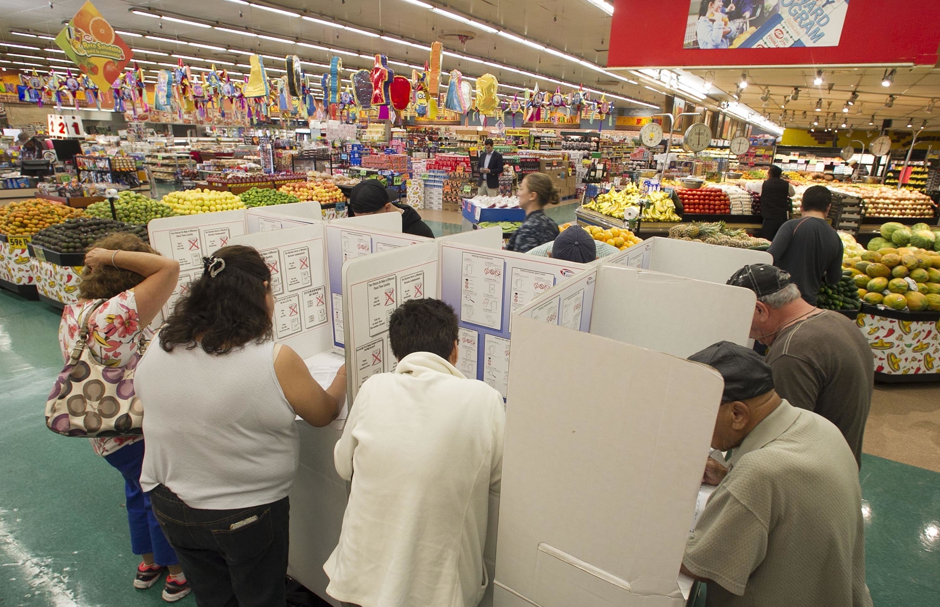 Voters cast their ballots on Election Day at the Foodland Grocery Store and Mercado in National City section in San Diego on Tuesday, Nov. 8, 2016.    (John Gibbins/The San Diego Union-Tribune via AP)