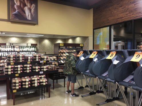 A man votes in the bakery department at a Randalls grocery store in Austin, Texas, on Tuesday, Nov. 8, 2016. (Jay Janner/Austin American-Statesman via AP)