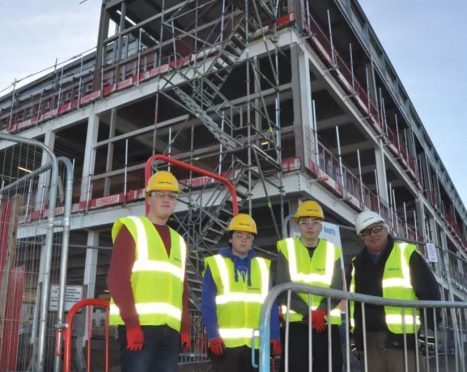 Elgin High pupils Craig Alexander, Jake Innes and Rowan Duncan with site manager Iain Mackie