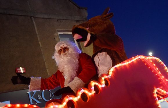 Santa and Rudolph in their sleigh as part of the parade through Ellon.