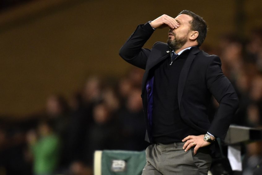 Aberdeen manager Derek McInnes stands dejected