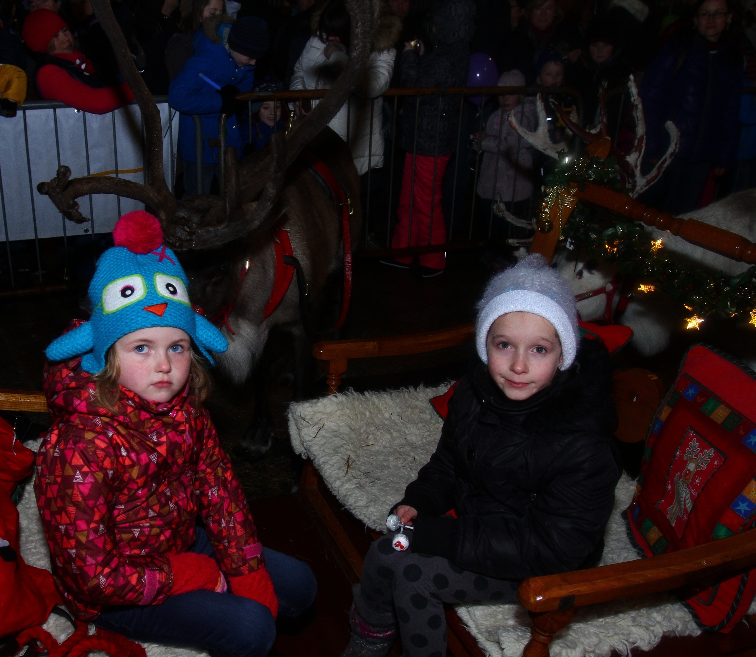 Santas little helpers Alice MacDonald left and Zara Macleod wait to help dish out lolipops as Santa arrives in station square after the parade down George Street in Oban part of the annual winter festival 